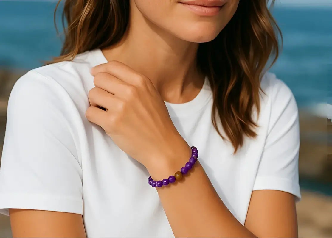 Woman wearing a purple bracelet on a beach