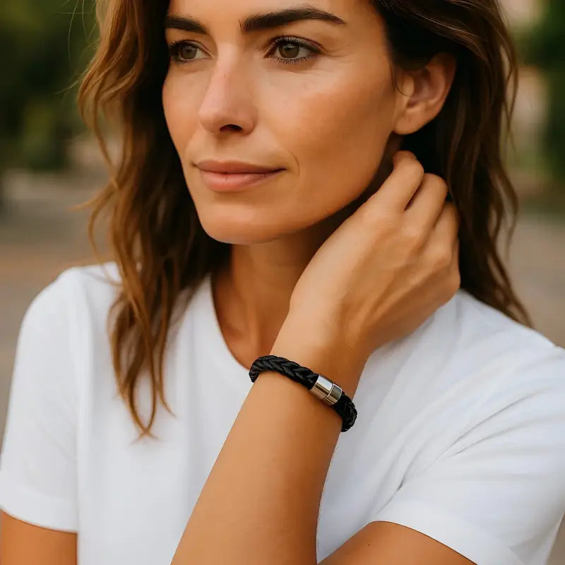 Sleek black leather bracelet with beads and silver magnetic clasp on woman’s wrist
