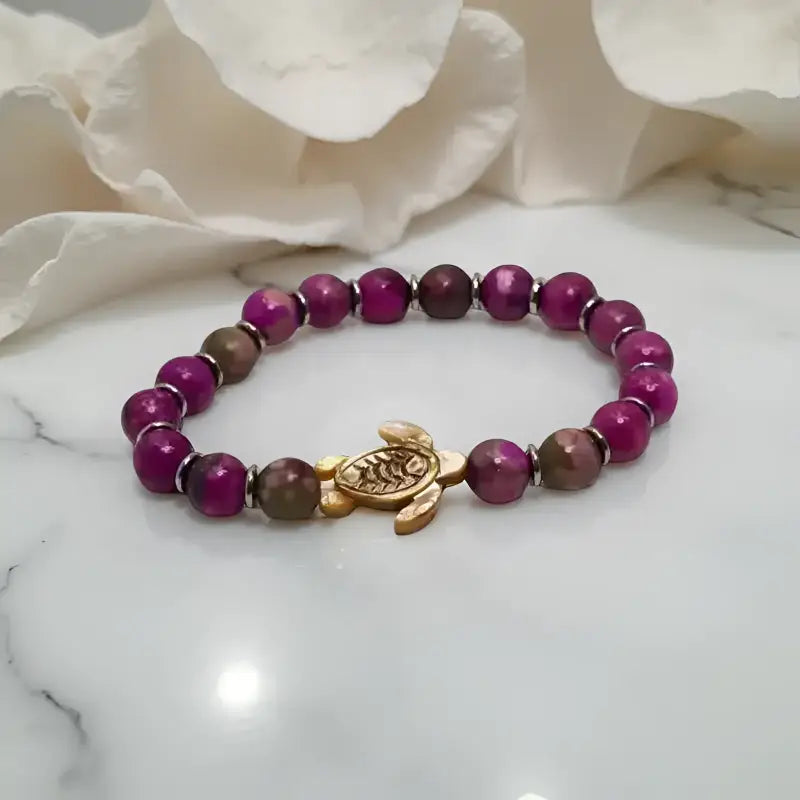 Beaded bracelet with turtle charm showcasing Gold Tiger Eye and Purple Jasper Beaded gemstones