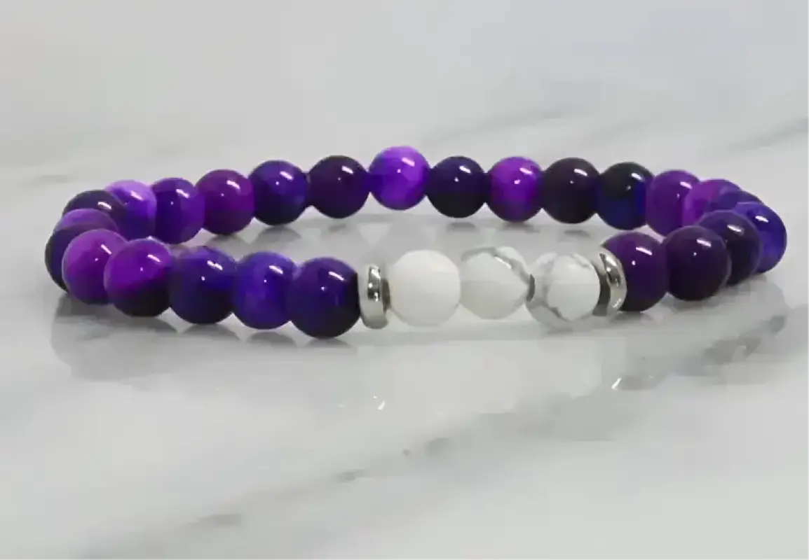 Purple and white howlite stretch bracelet with metallic accents for stylish accessory
