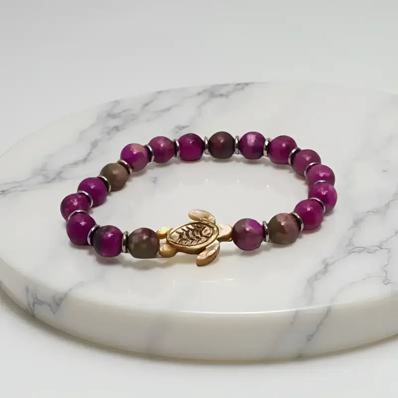 Beaded Sugilite Turtle Bracelet with Stainless Steel Spacers featuring a turtle charm