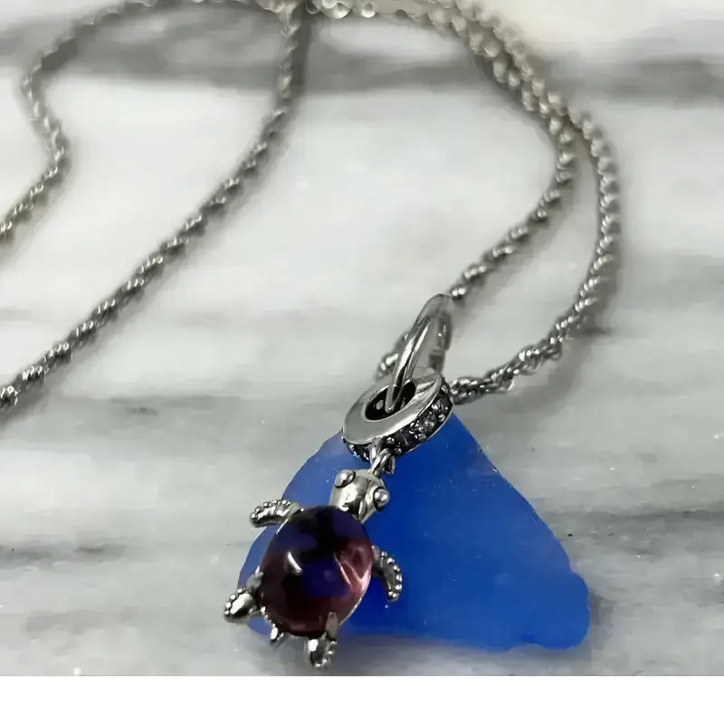 Silver sea glass turtle pendant necklace with blue glass charm in Bec Sue Jewelry
