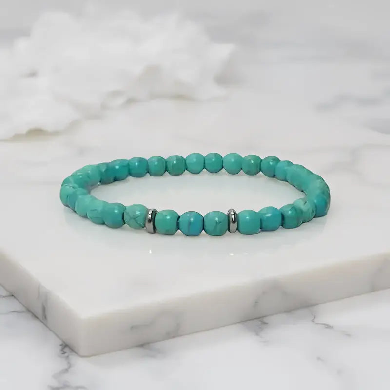 Turquoise beaded stretch bracelet featuring silver spacer beads and 6mm size