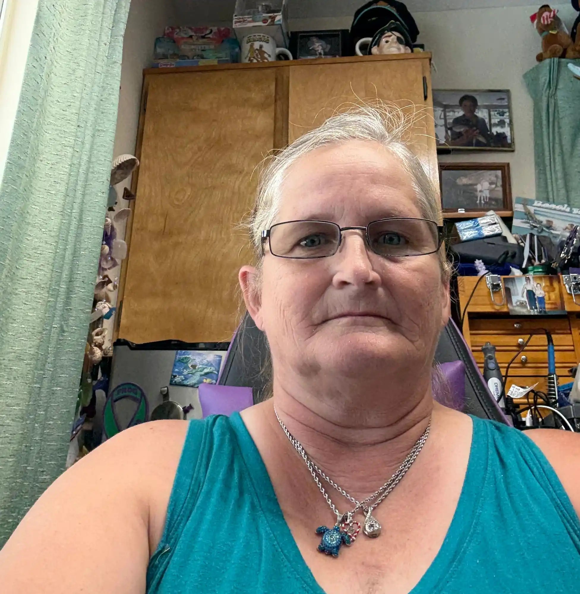 Woman wearing glasses and a necklace.