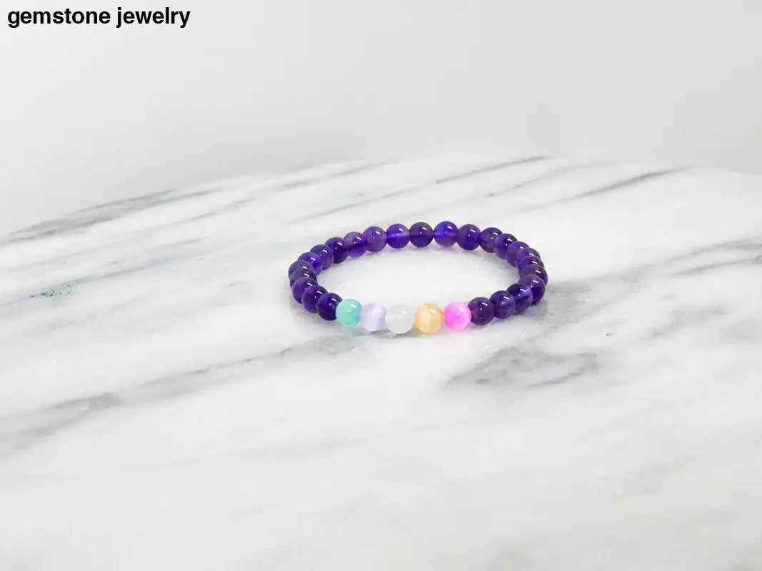 Purple beaded Selenite bracelet with rainbow accents for protective energy