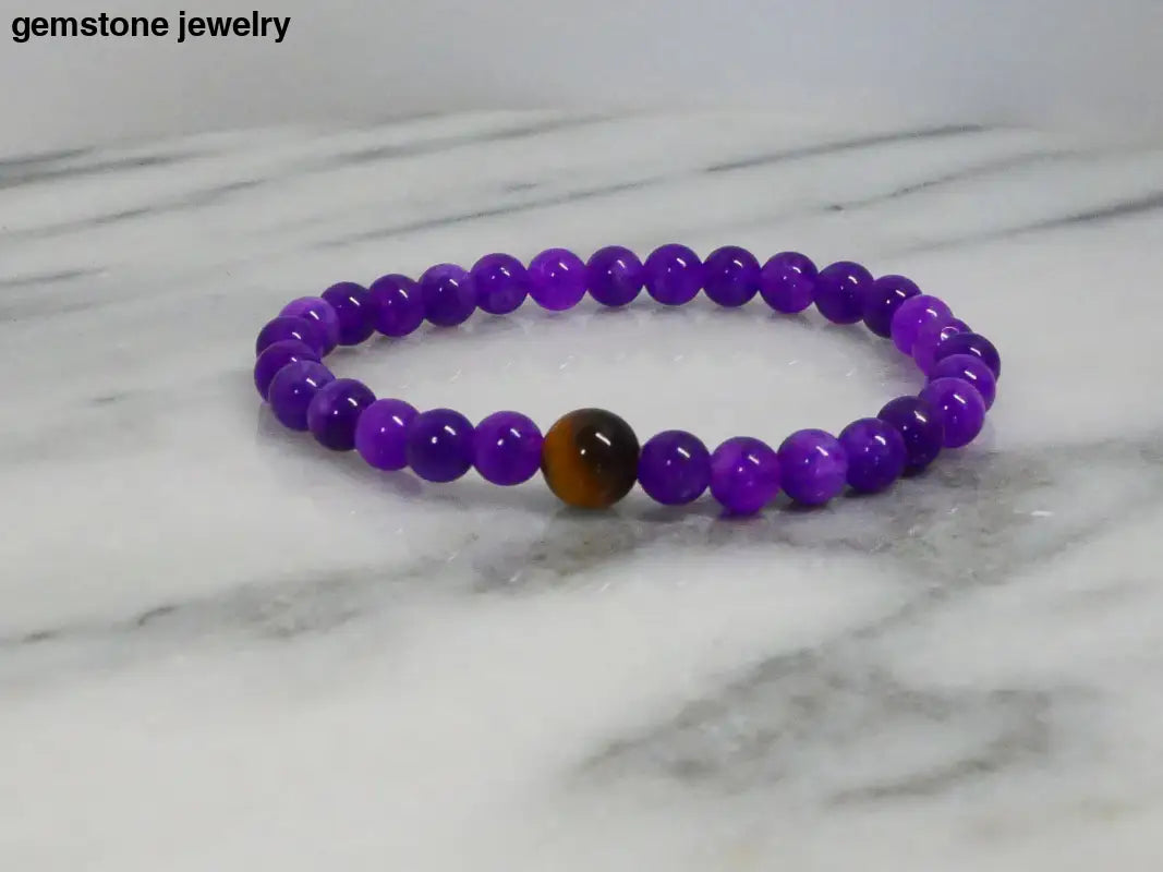 Amethyst Stretch Bracelet with brown accent bead from Bec Sue Jewelry displayed elegantly