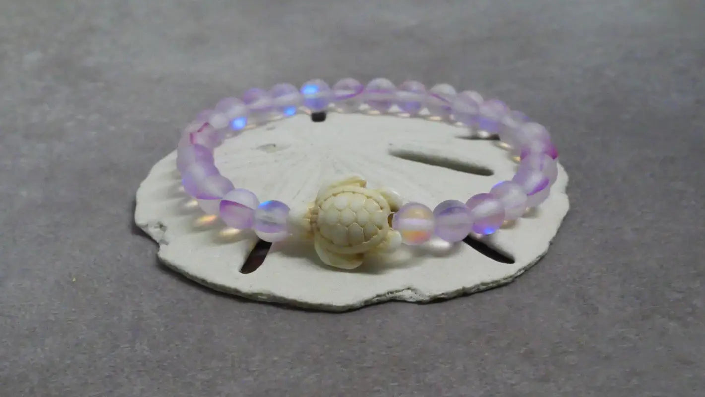 Iridescent beaded bracelet with turtle charm, perfect for beads and decor accessories