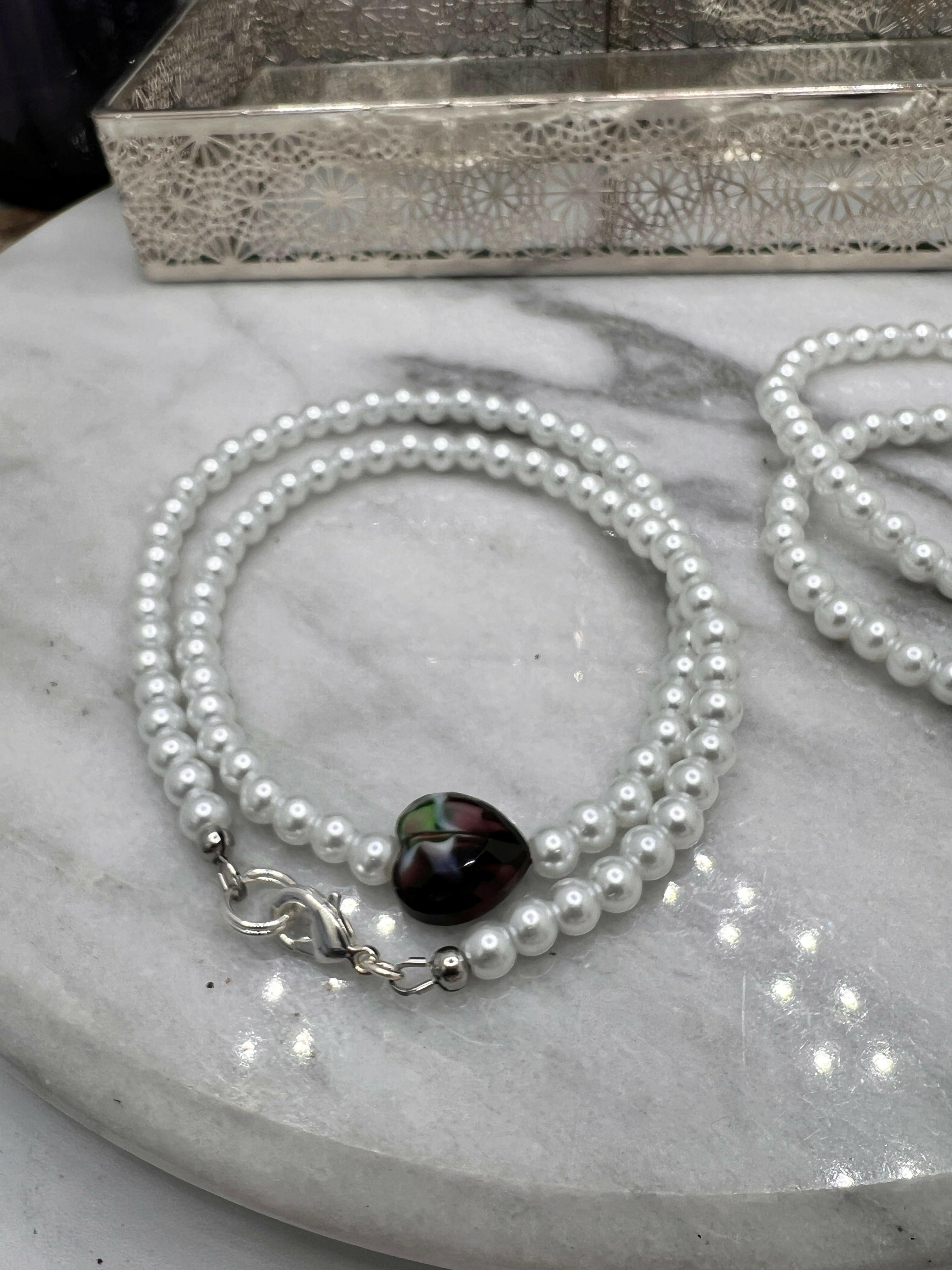 Classic white glass pearl necklace paired with matching bracelet for a sophisticated touch.