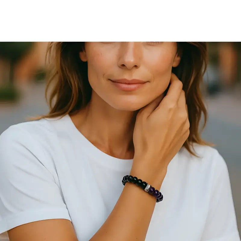 Woman wearing handmade gemstone jewelry purple onyx stretch bracelet with silver-toned crystal bead