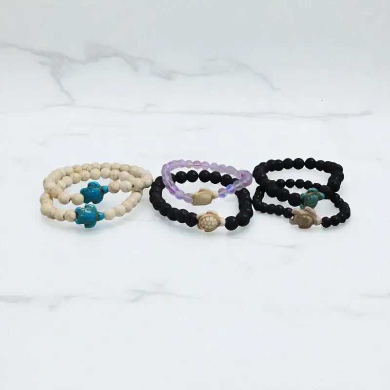 Lava stone bracelet with beaded turtle charms and carved bone accents for unique style