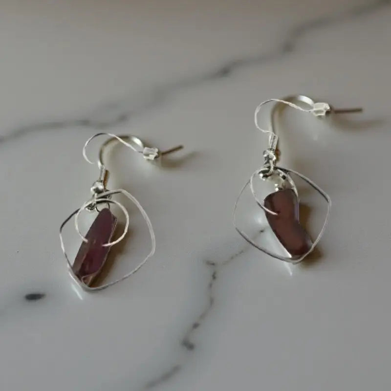 Pair of silver earrings with purple stones, part of Red Glass Earrings with Silver Frames collection