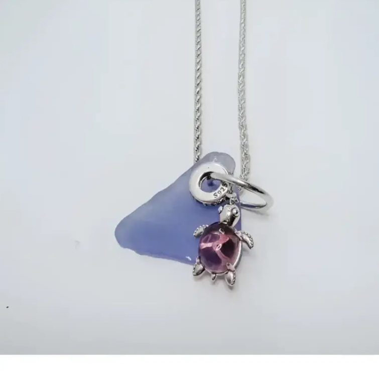 Silver sea glass turtle pendant necklace with purple gemstone charm from Bec Sue Jewelry