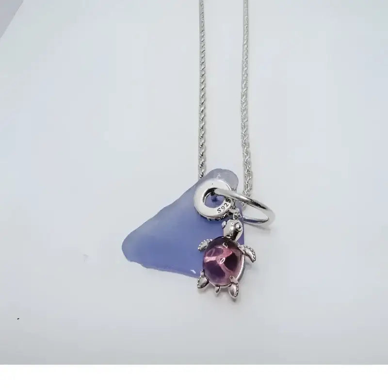 Silver sea glass turtle pendant necklace with purple gemstone charm from Bec Sue Jewelry