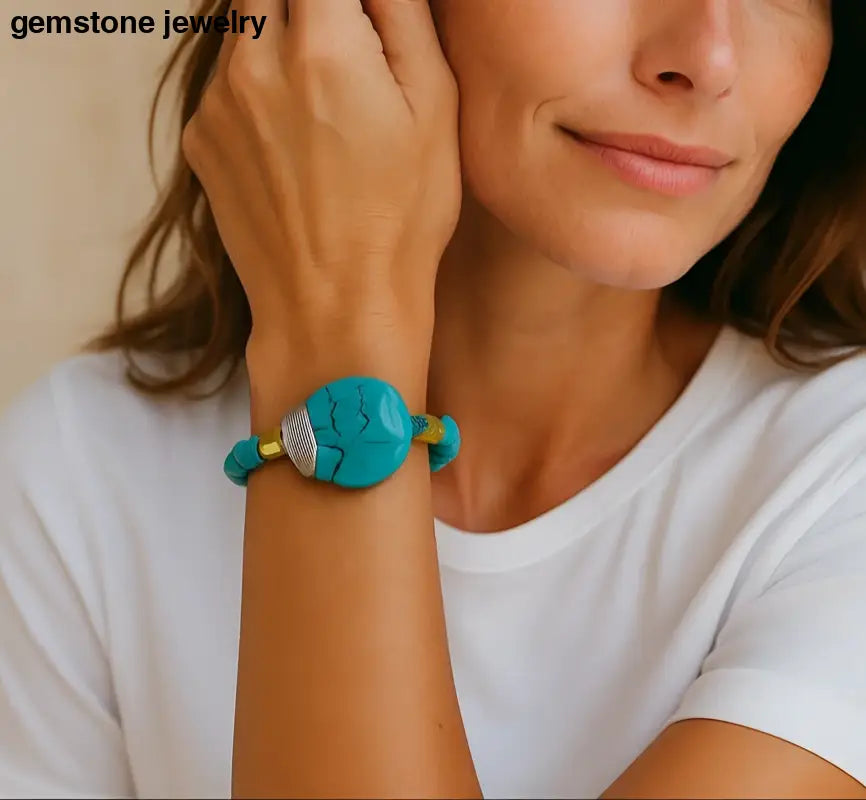 Woman wearing a turquoise bracelet with a blurred outdoor background